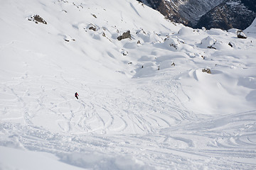 Image showing freeride skier skiing in deep powder snow