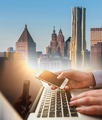 Image showing The businessman with laptop and city