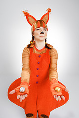 Image showing Young woman in the image of red squirrel with cookies