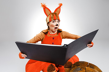 Image showing Young woman in the image of red squirrel with big book