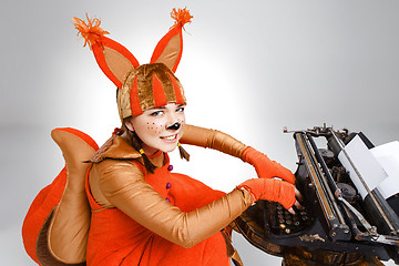 Image showing Young woman in image of squirrel with a retro typewriter