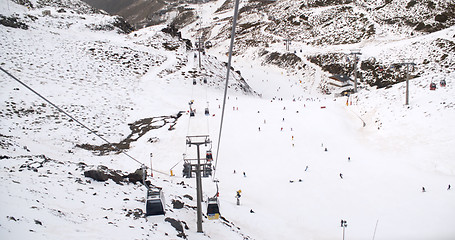 Image showing View from a ski lift of skiers below on run