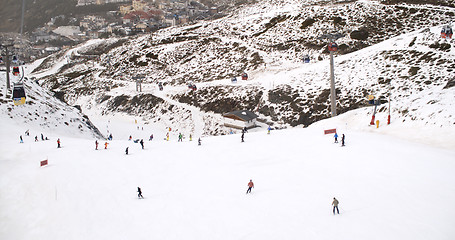 Image showing View from a ski lift of skiers below on run