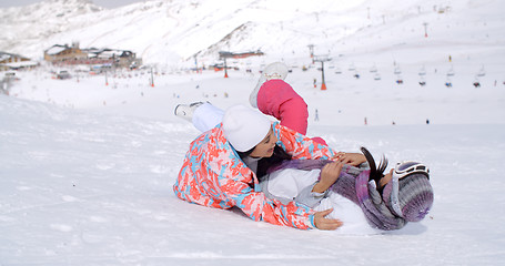 Image showing Two young woman enjoying a frolic in the snow