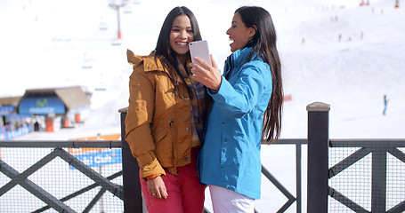 Image showing Two young women laughing at their selfie