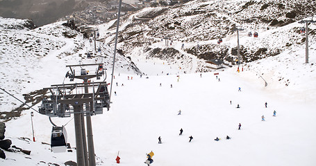 Image showing View from a ski lift of skiers below on run