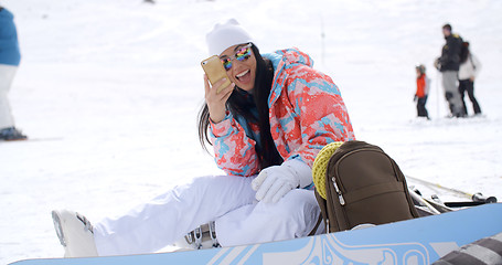 Image showing Happy young woman posing for a selfie in the snow