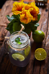 Image showing fresh mojito on a rustic table.