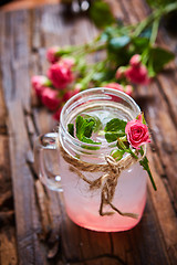 Image showing fresh mojito on a rustic table.