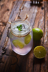 Image showing fresh mojito on a rustic table.