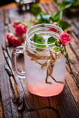 Image showing fresh mojito on a rustic table.