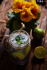 Image showing fresh mojito on a rustic table.