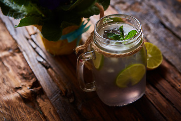 Image showing fresh mojito on a rustic table.