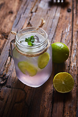 Image showing fresh mojito on a rustic table.