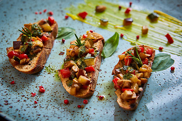 Image showing Vegan food: bruschetta with bell pepper, tomatoes, arugula, thyme and basil