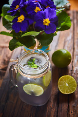 Image showing fresh mojito on a rustic table.