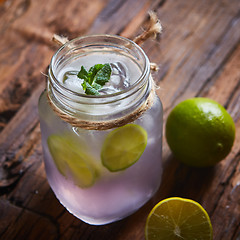 Image showing fresh mojito on a rustic table.