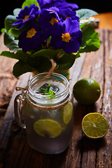 Image showing fresh mojito on a rustic table.