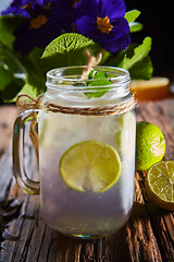 Image showing fresh mojito on a rustic table.