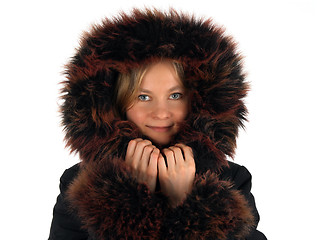 Image showing Smiling winter girl with a fur hood