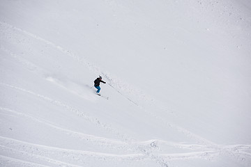 Image showing freeride skier skiing in deep powder snow