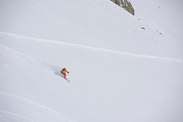 Image showing freeride skier skiing in deep powder snow