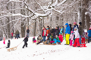 Image showing Winter fun, snow, family sledding at winter time.