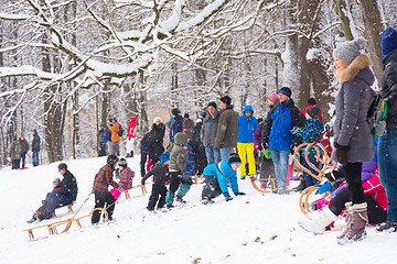 Image showing Winter fun, snow, family sledding at winter time.