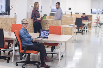 Image showing portrait of young business woman at office with team in backgrou