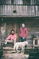 Image showing frineds together in front of old wooden house