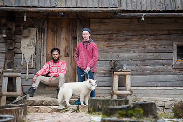 Image showing frineds together in front of old wooden house