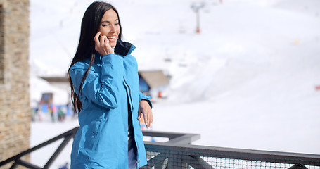 Image showing Attractive young woman at a mountain ski resort