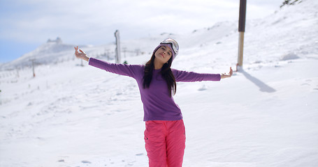 Image showing Happy young woman embracing the winter sun