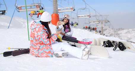 Image showing Two attractive female snowboarders