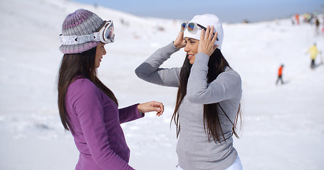 Image showing Two stylish young woman chatting at a ski resort