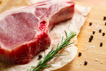 Image showing Pieces of crude meat with rosemary and spices