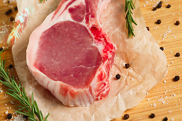 Image showing Pieces of crude meat with rosemary and spices