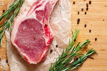 Image showing Pieces of crude meat with rosemary and spices