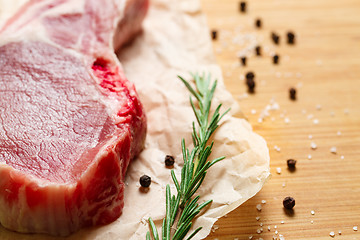 Image showing Pieces of crude meat with rosemary and spices