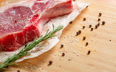 Image showing Pieces of crude meat with rosemary and spices