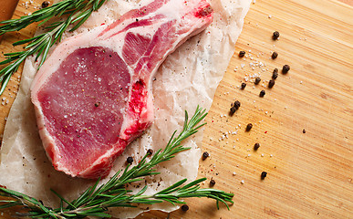 Image showing Pieces of crude meat with rosemary and spices