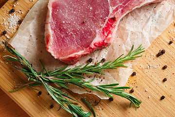 Image showing Pieces of crude meat with rosemary and spices