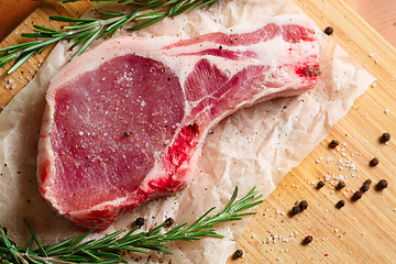 Image showing Pieces of crude meat with rosemary and spices