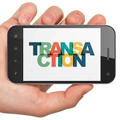 Image showing Banking concept: Hand Holding Smartphone with Transaction on  display