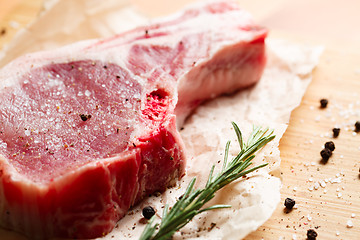 Image showing Pieces of crude meat with rosemary and spices