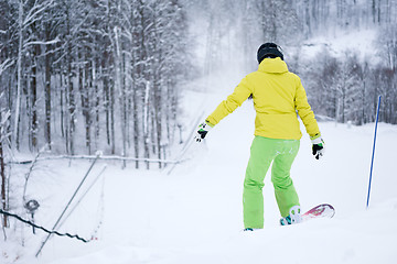 Image showing Snowboarder riding on background beautiful mountain landscape