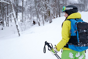 Image showing Female skier standing on background beautiful landscape of snowy mountains.