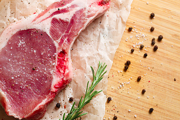 Image showing Pieces of crude meat with rosemary and spices