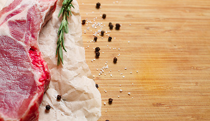 Image showing Pieces of crude meat with rosemary and spices