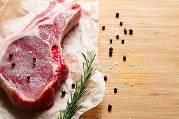 Image showing Pieces of crude meat with rosemary and spices